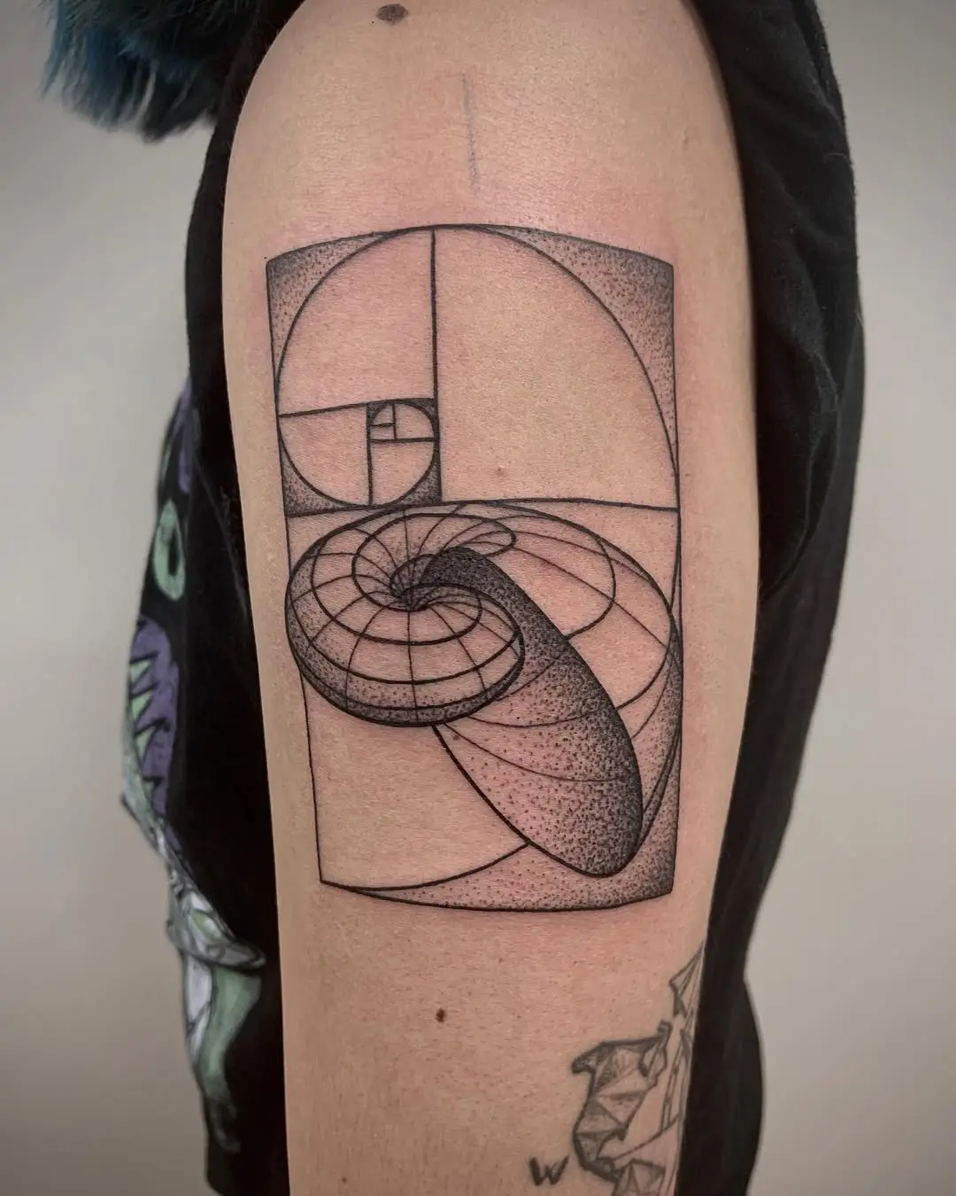 Intricate Fibonacci spiral tattoo in black ink