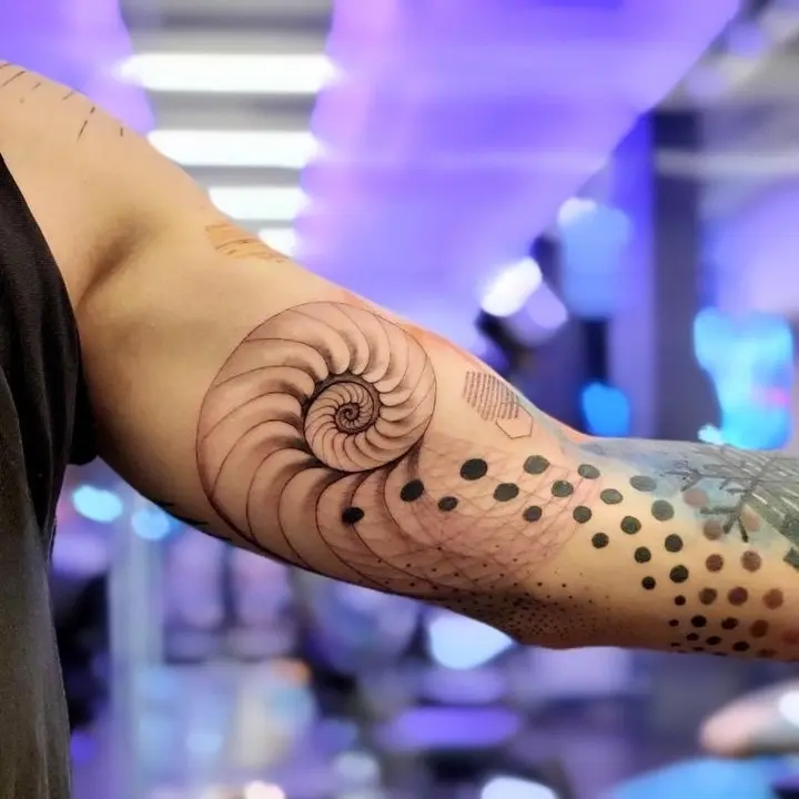 Intricate Fibonacci spiral tattoo design on arm
