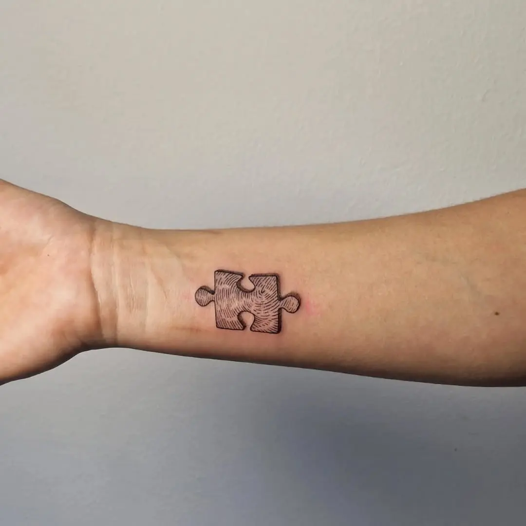 Intricate fingerprint puzzle piece tattoo design