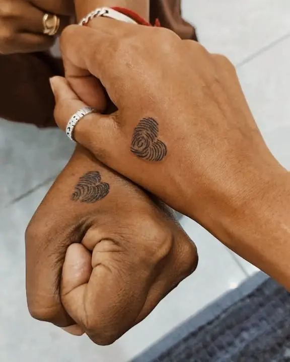 Unique fingerprint heart tattoos on hands