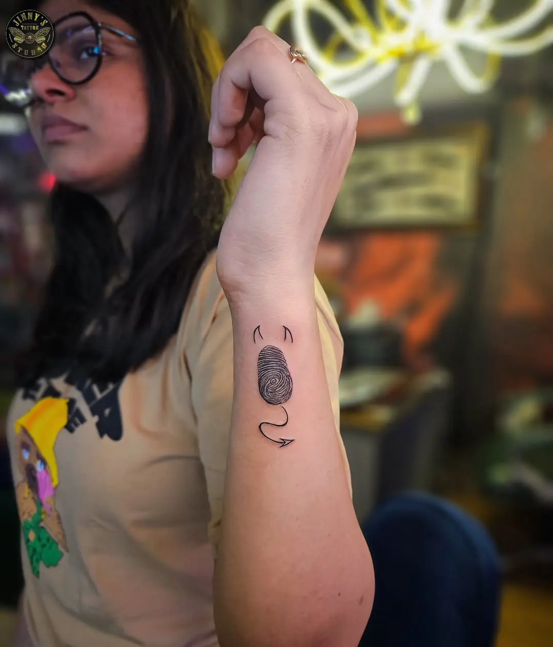 Artistic Fingerprint Tattoo Design on Arm