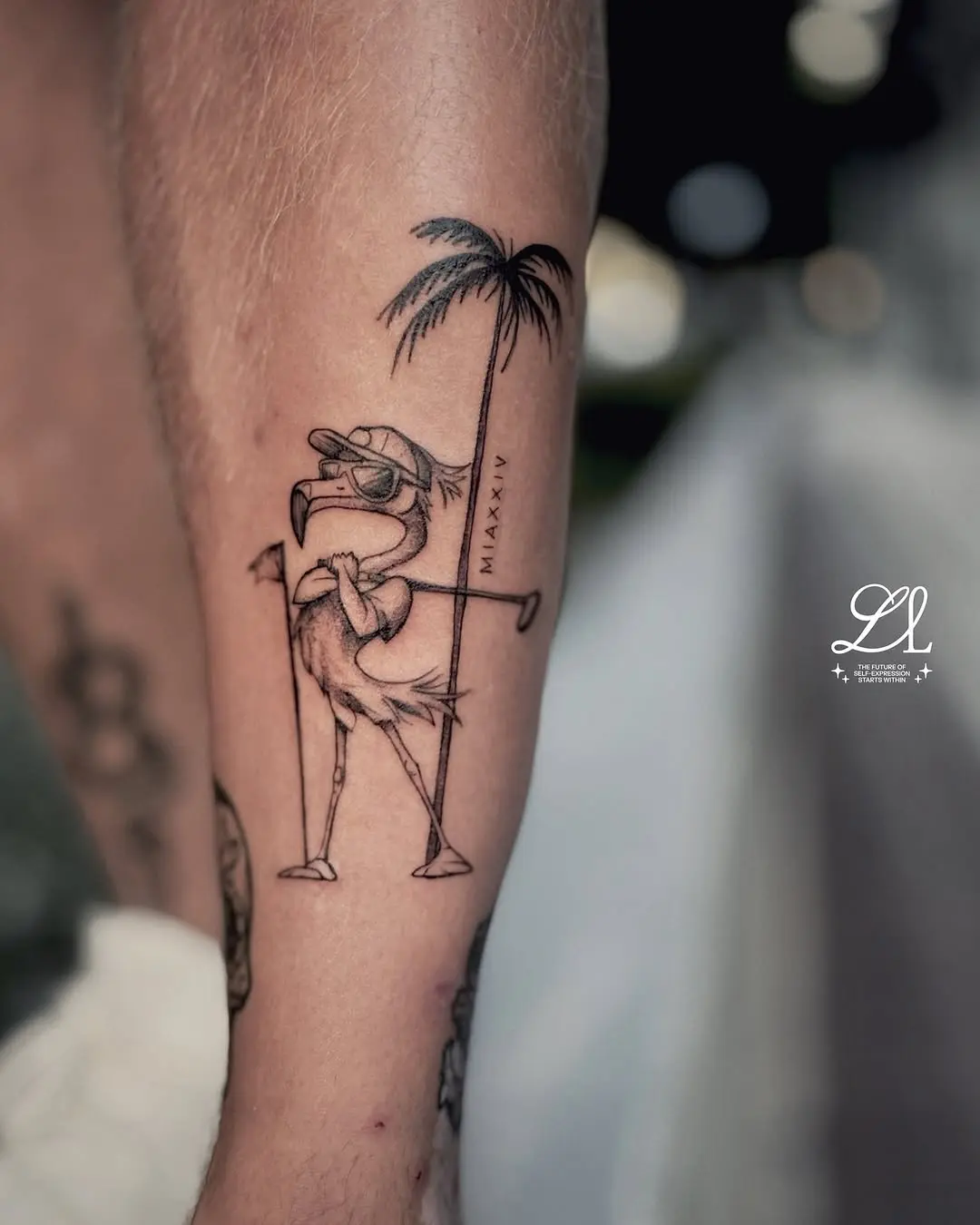 Playful flamingo golfer under palm tree tattoo