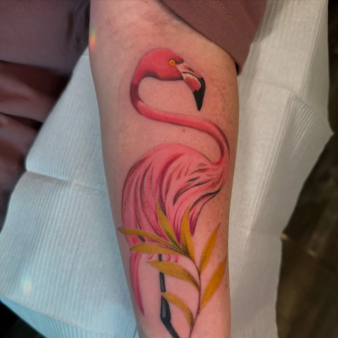 Vibrant Flamingo Tattoo with Lush Greens