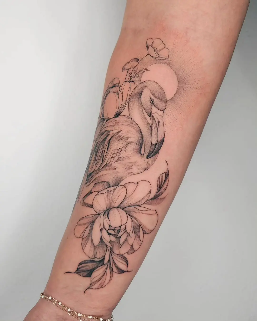 Elegant flamingo tattoo with floral accents