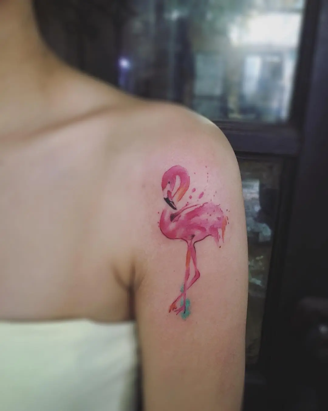 Colorful watercolor flamingo tattoo on shoulder