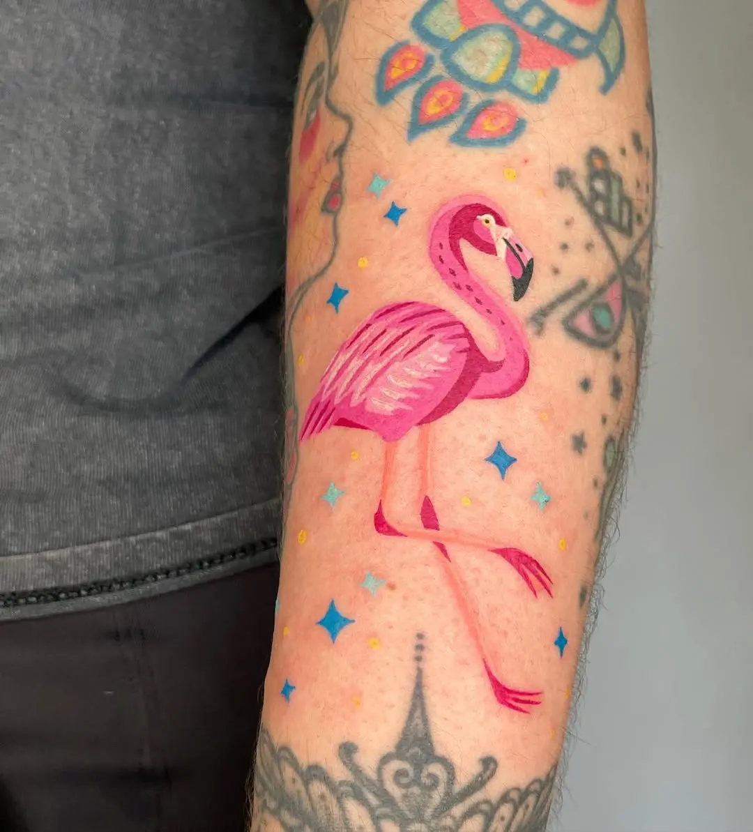 Vibrant flamingo tattoo with playful star accents