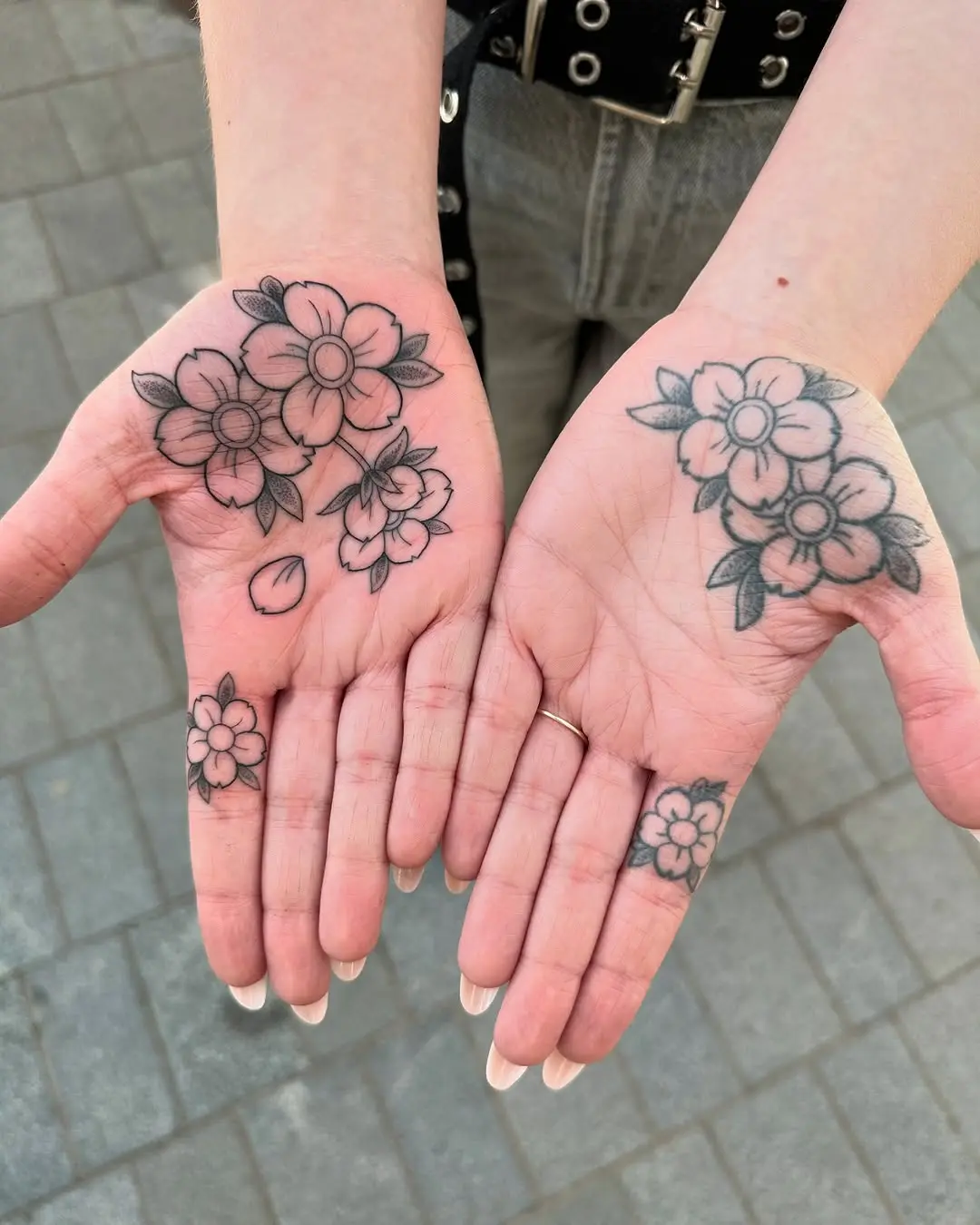 Delicate flower tattoos on both palms