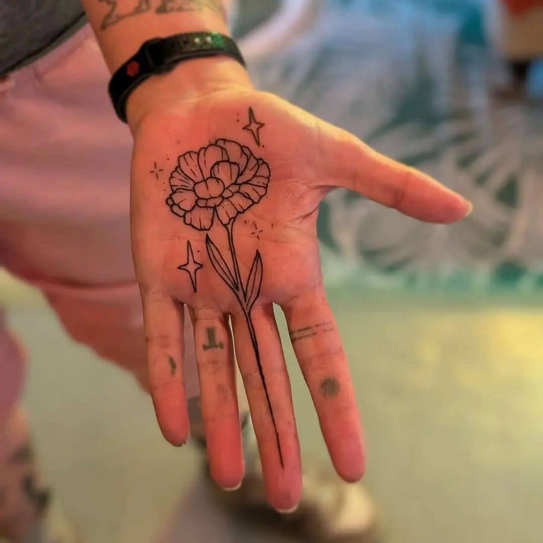 Elegant flower palm tattoo with star accents