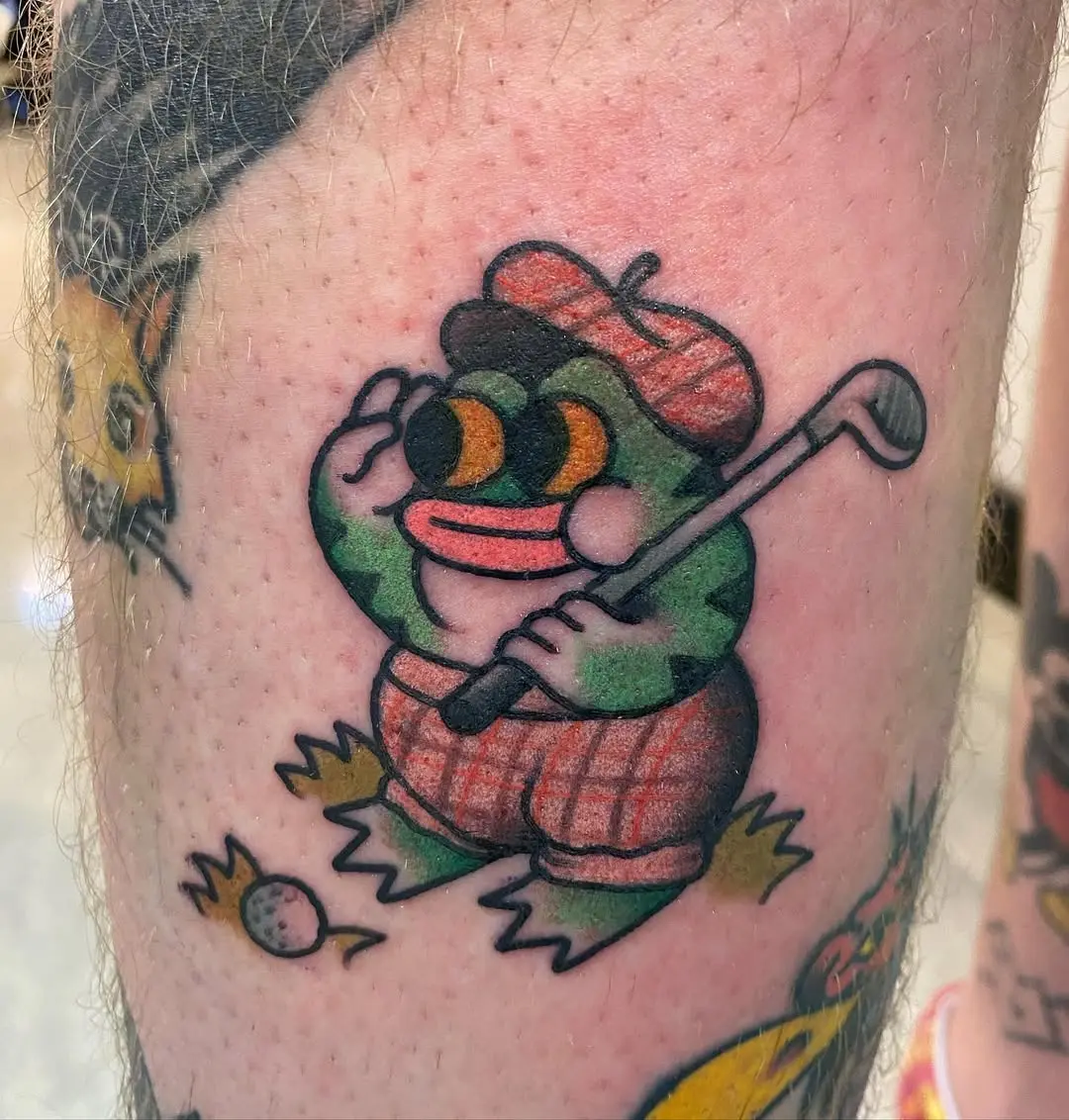 Playful frog golfer tattoo with whimsical charm