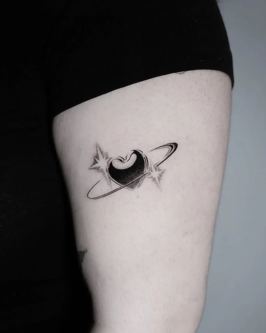 Celestial love etched in ink with planets.