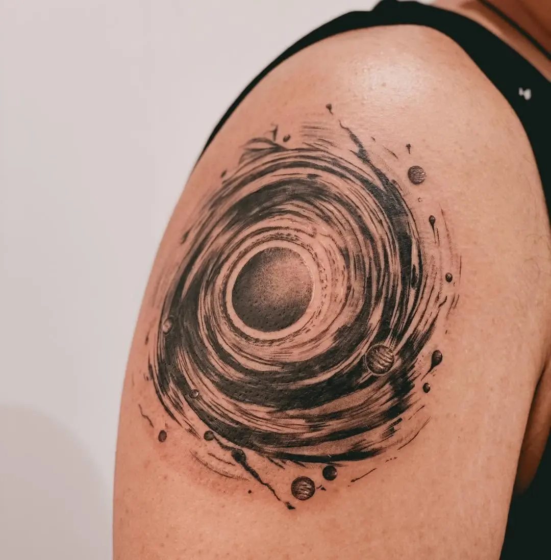 Unique galaxy swirl tattoo on shoulder