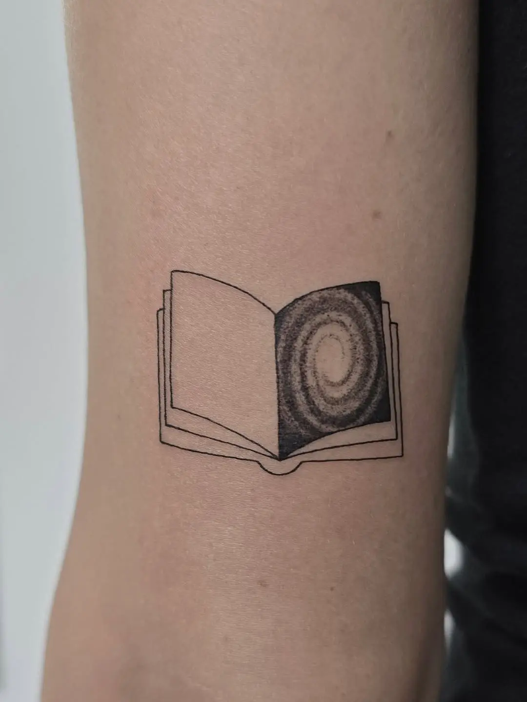 Creative galaxy book tattoo design inspiration