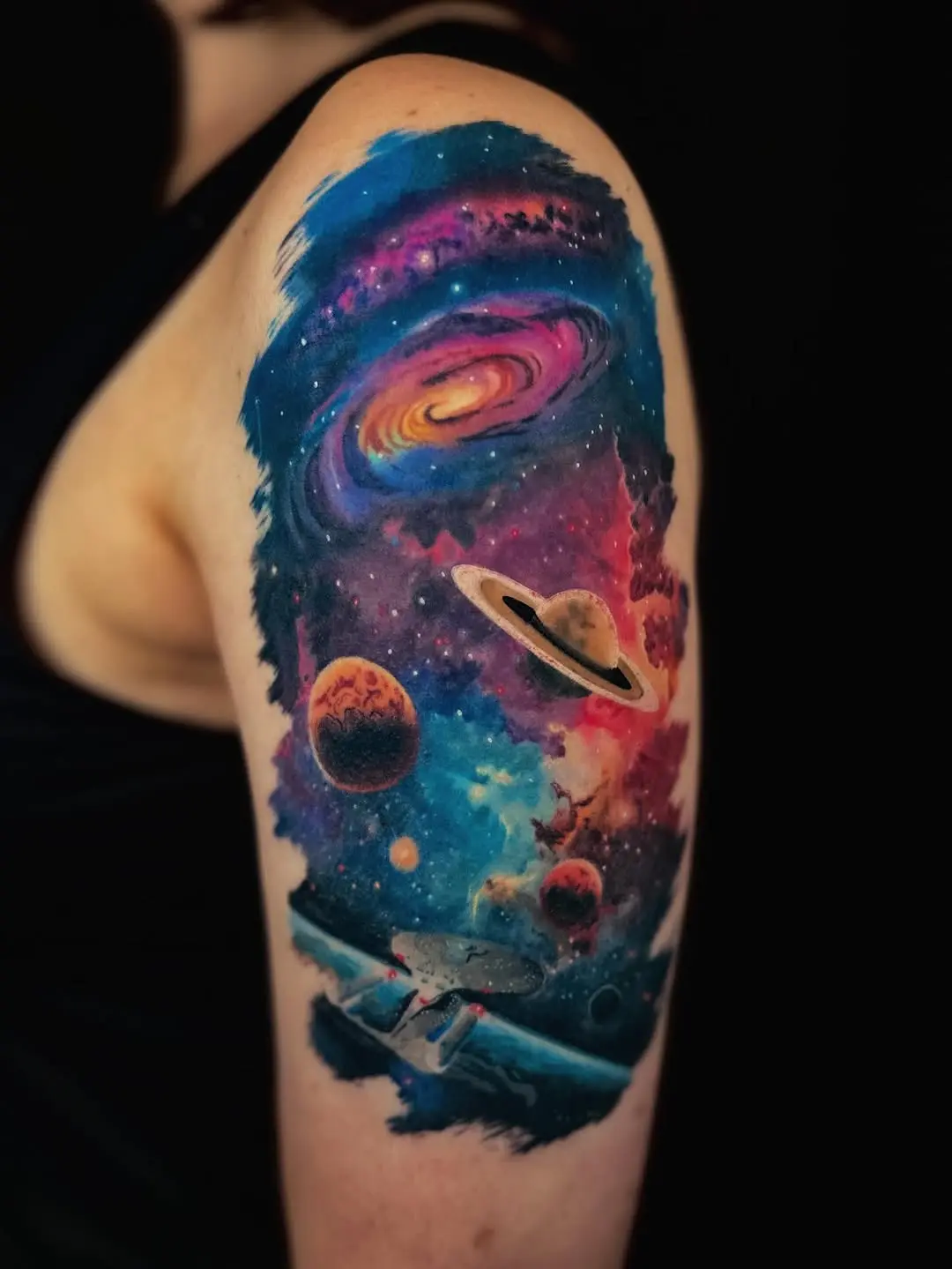 Colorful galaxy tattoo with planets and spaceship