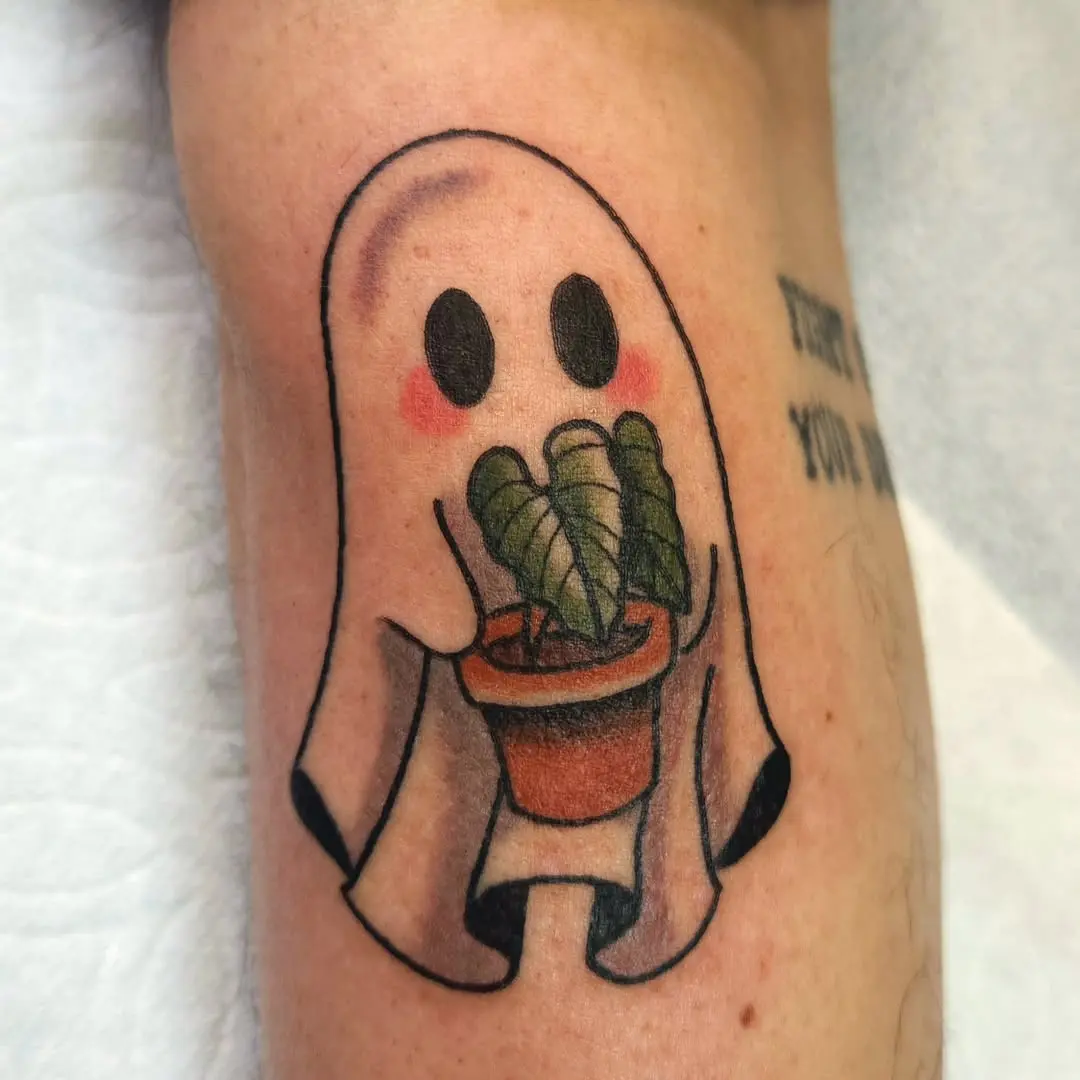 Adorable ghost cradling a plant pot tattoo
