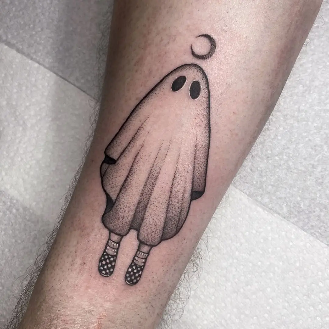 Whimsical ghost tattoo showcasing playful minimalism.