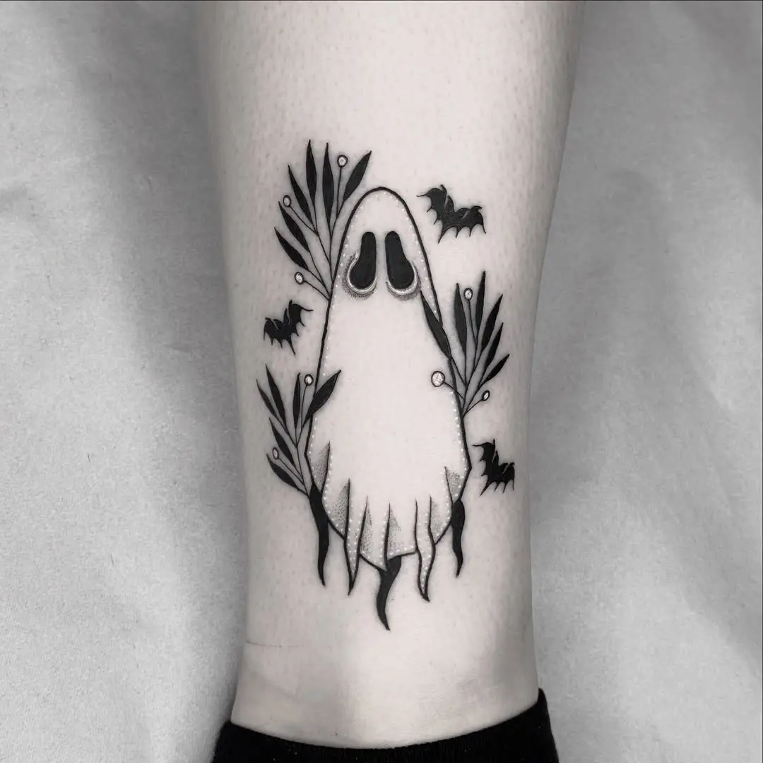 Charming and whimsical ghost tattoo with foliage