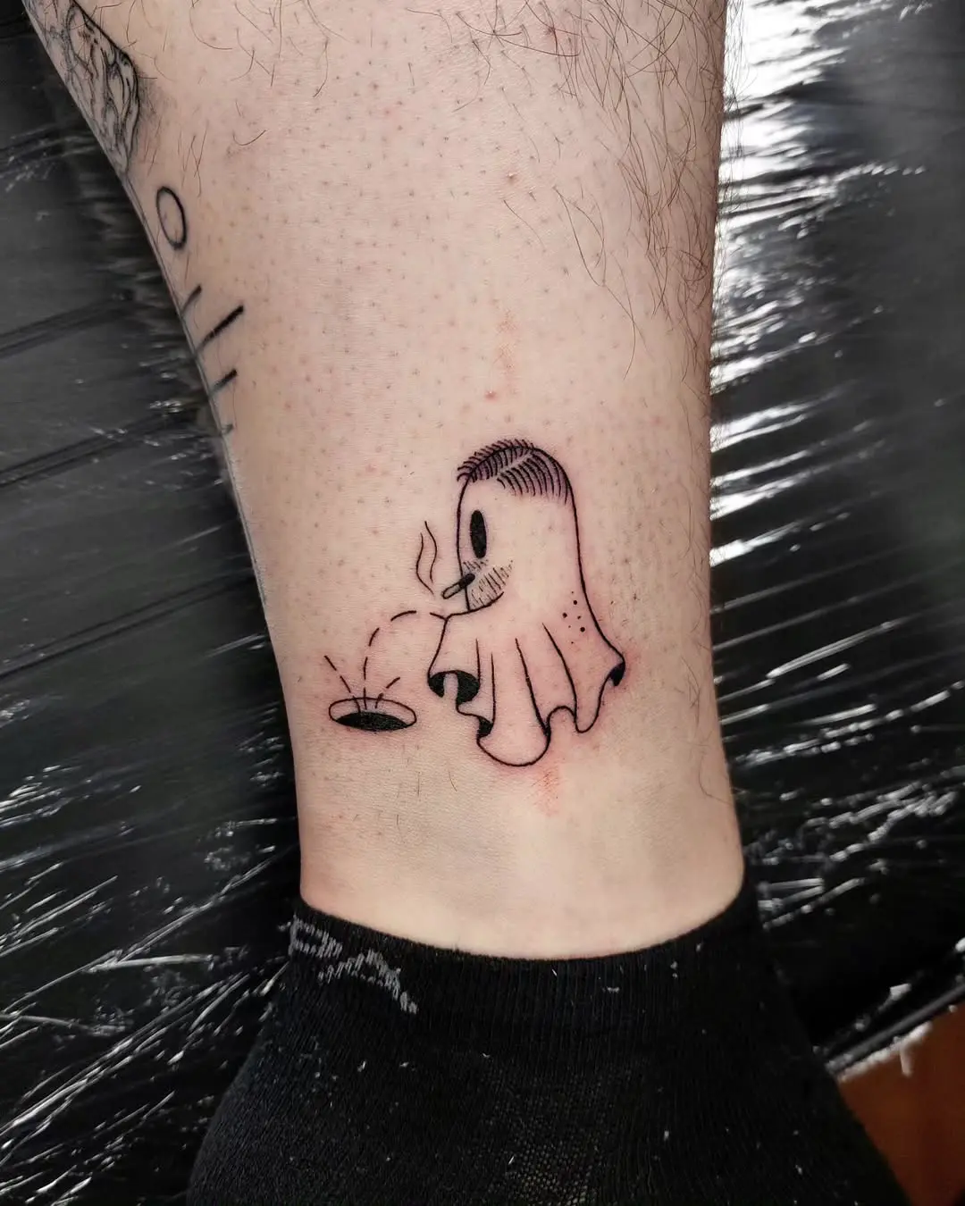 Whimsical ghost tattoo with playful vibes