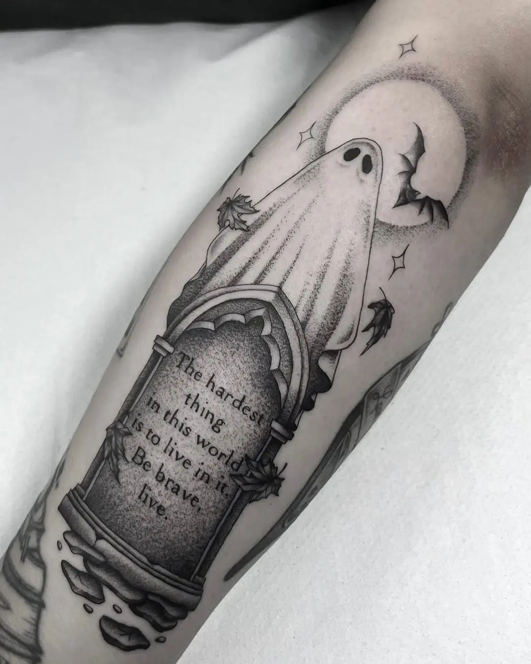 Eerie ghost tattoo on a gravestone design
