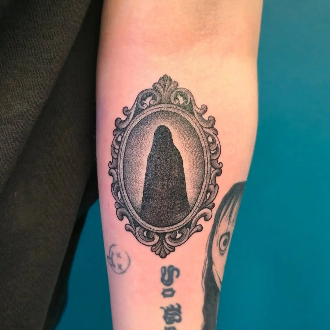 Elegant ghost tattoo in ornate frame design