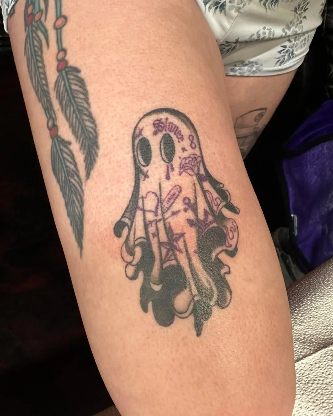 Charming ghost tattoo with playful elements