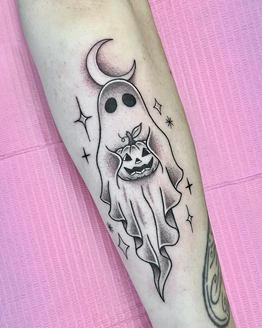 Playful ghost tattoo with crescent moon