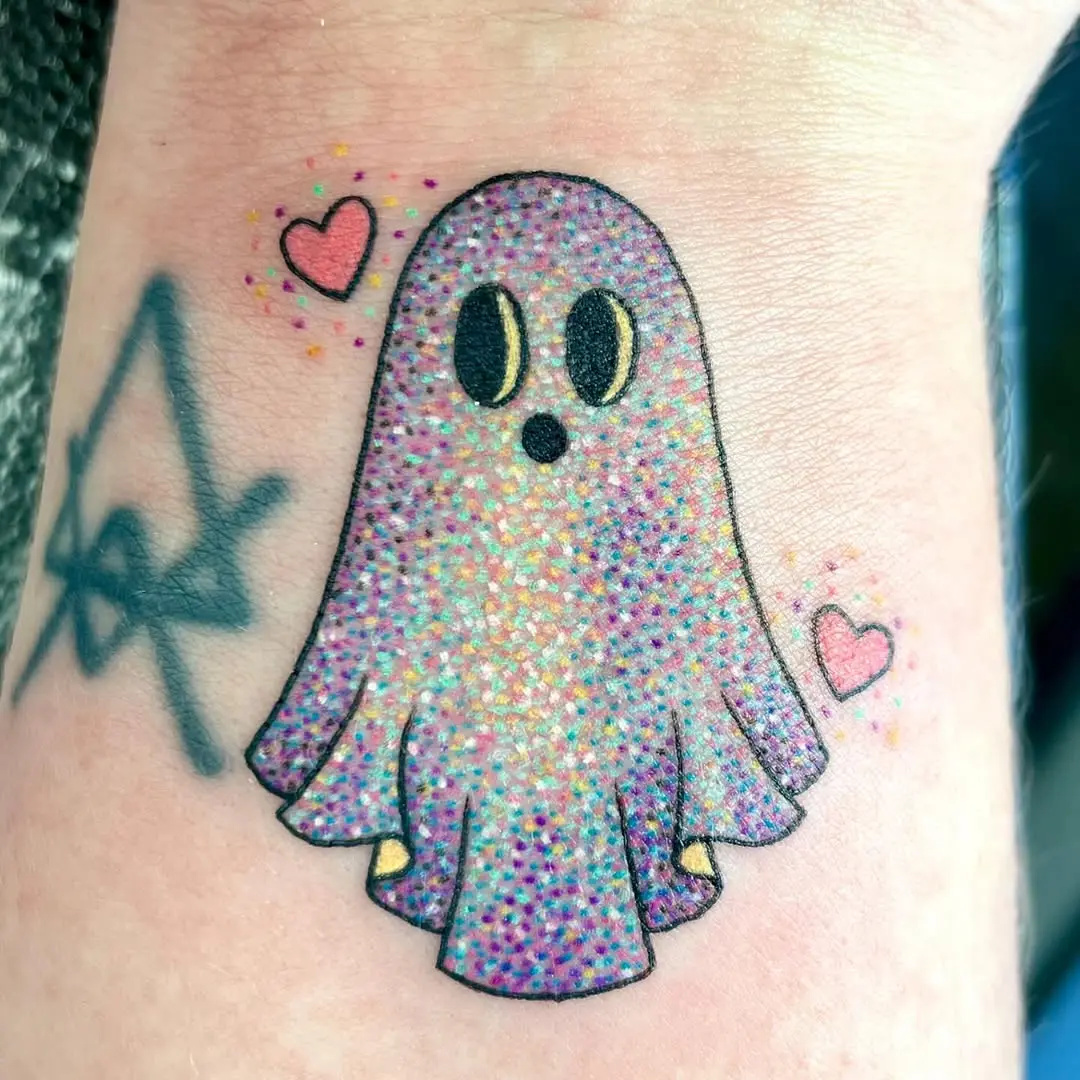 Whimsical glittery ghost tattoo with hearts