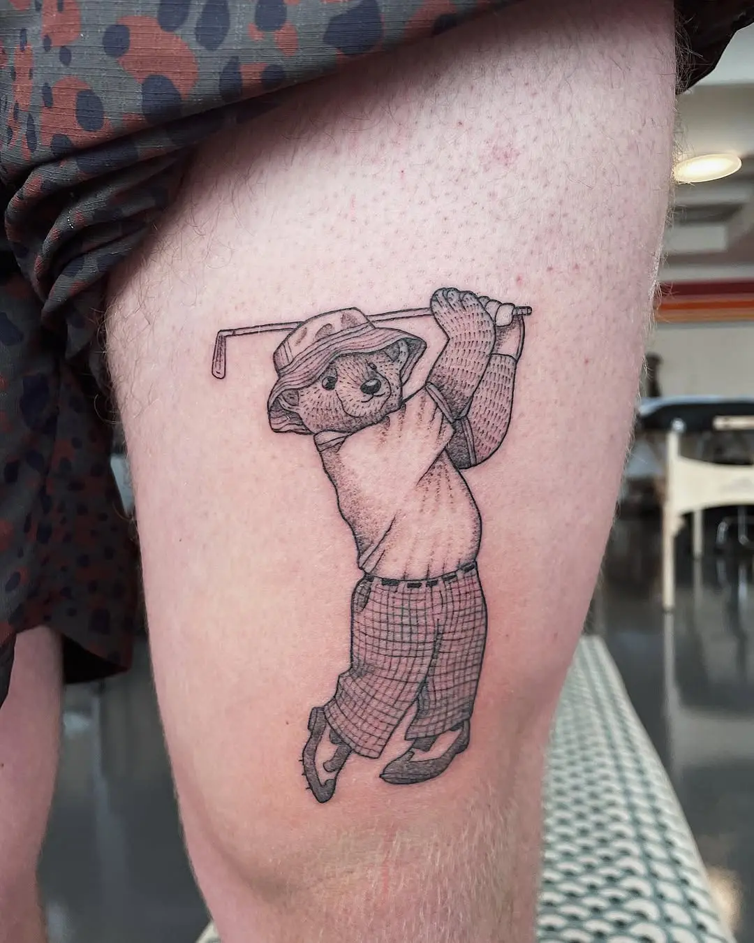 Playful koala golf tattoo with stylish attire