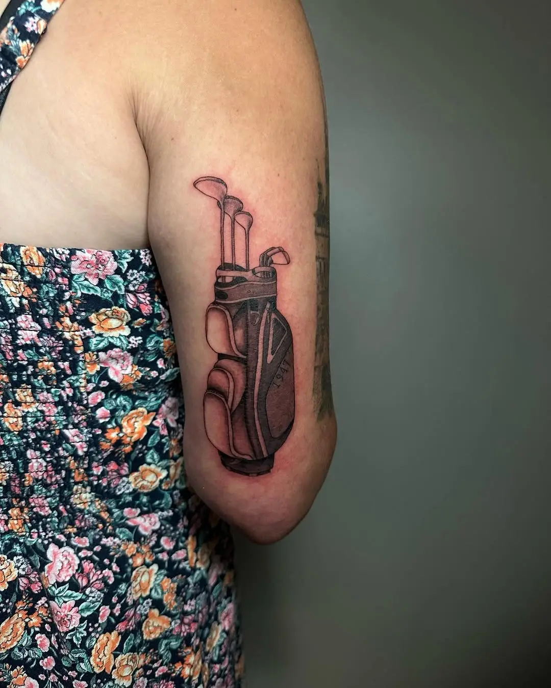 Detailed tattoo of golf clubs on arm
