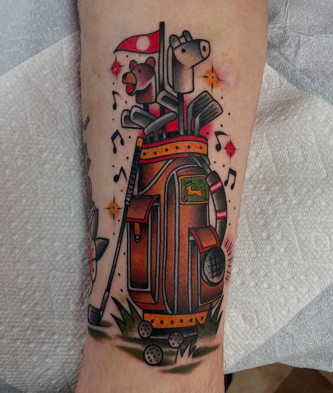 Whimsical golf bag tattoo with playful elements