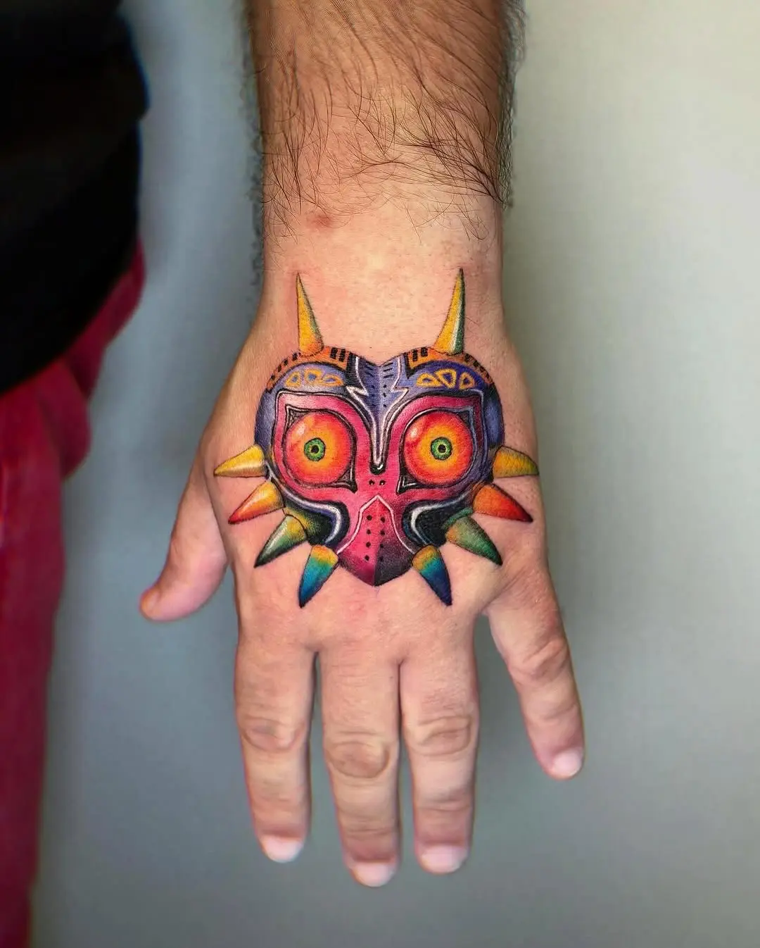 Vibrant Majora's Mask Hand Tattoo Design
