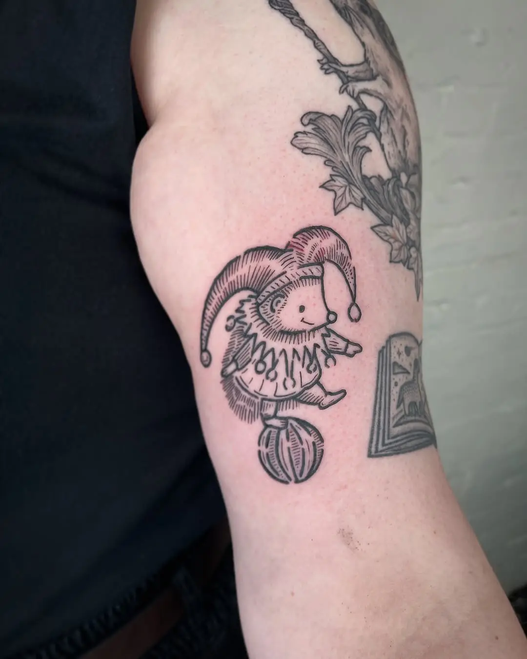 Playful hedgehog clown tattoo design