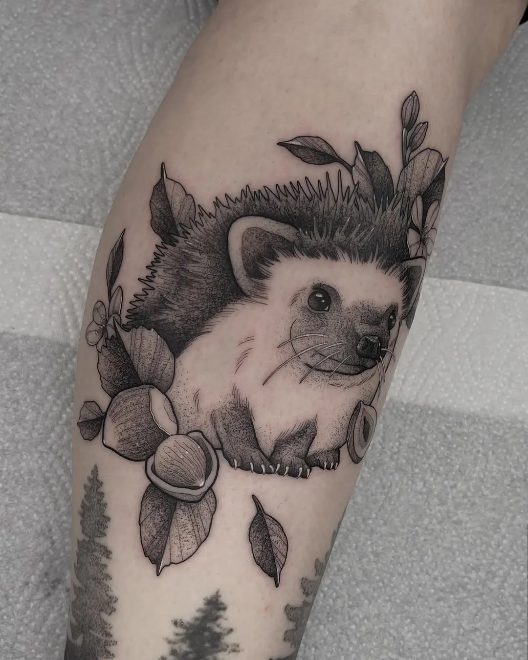 Charming hedgehog tattoo with elegant foliage design