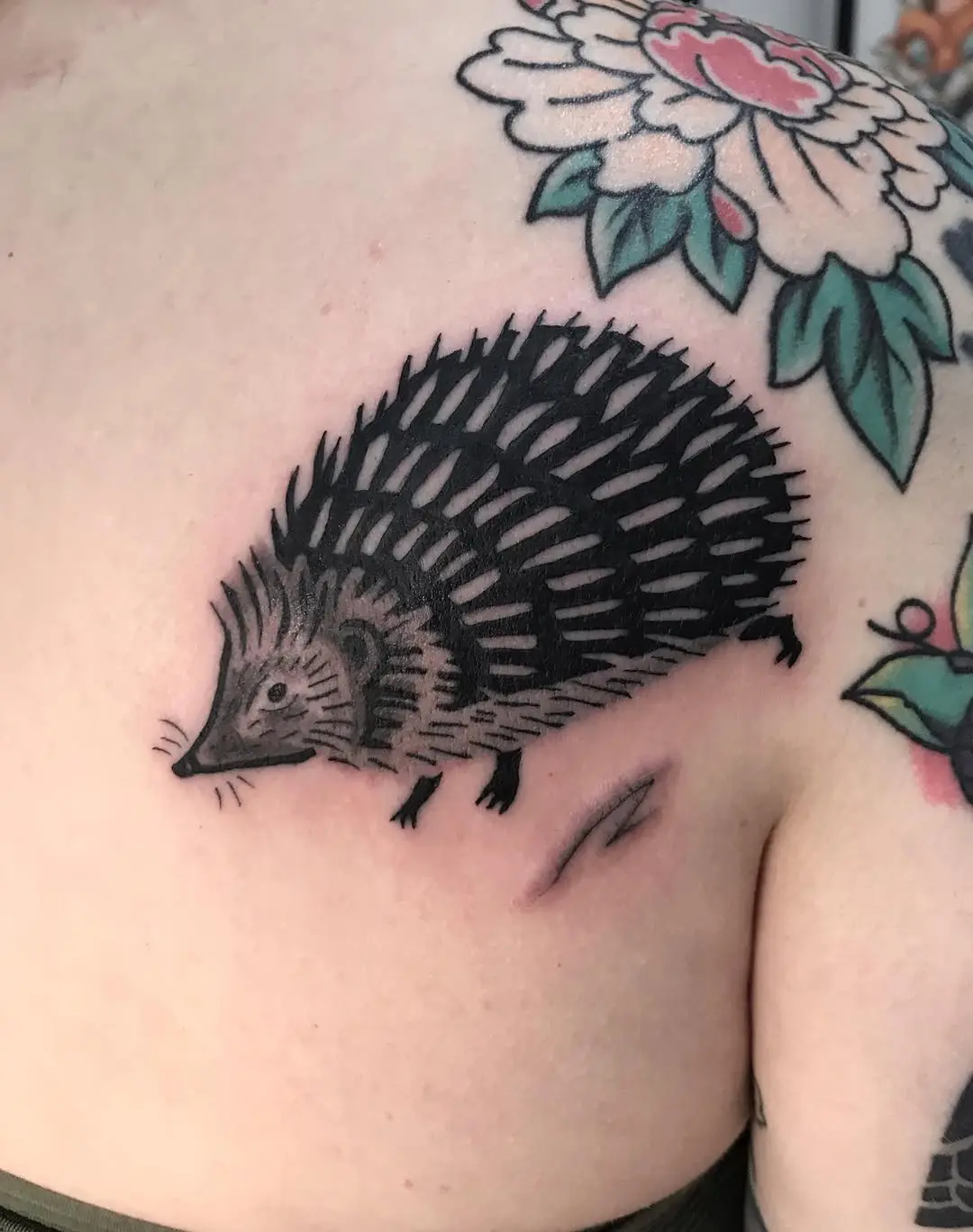 Charming black and grey hedgehog tattoo design