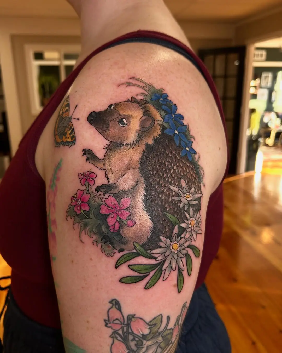 Charming hedgehog tattoo with floral elements