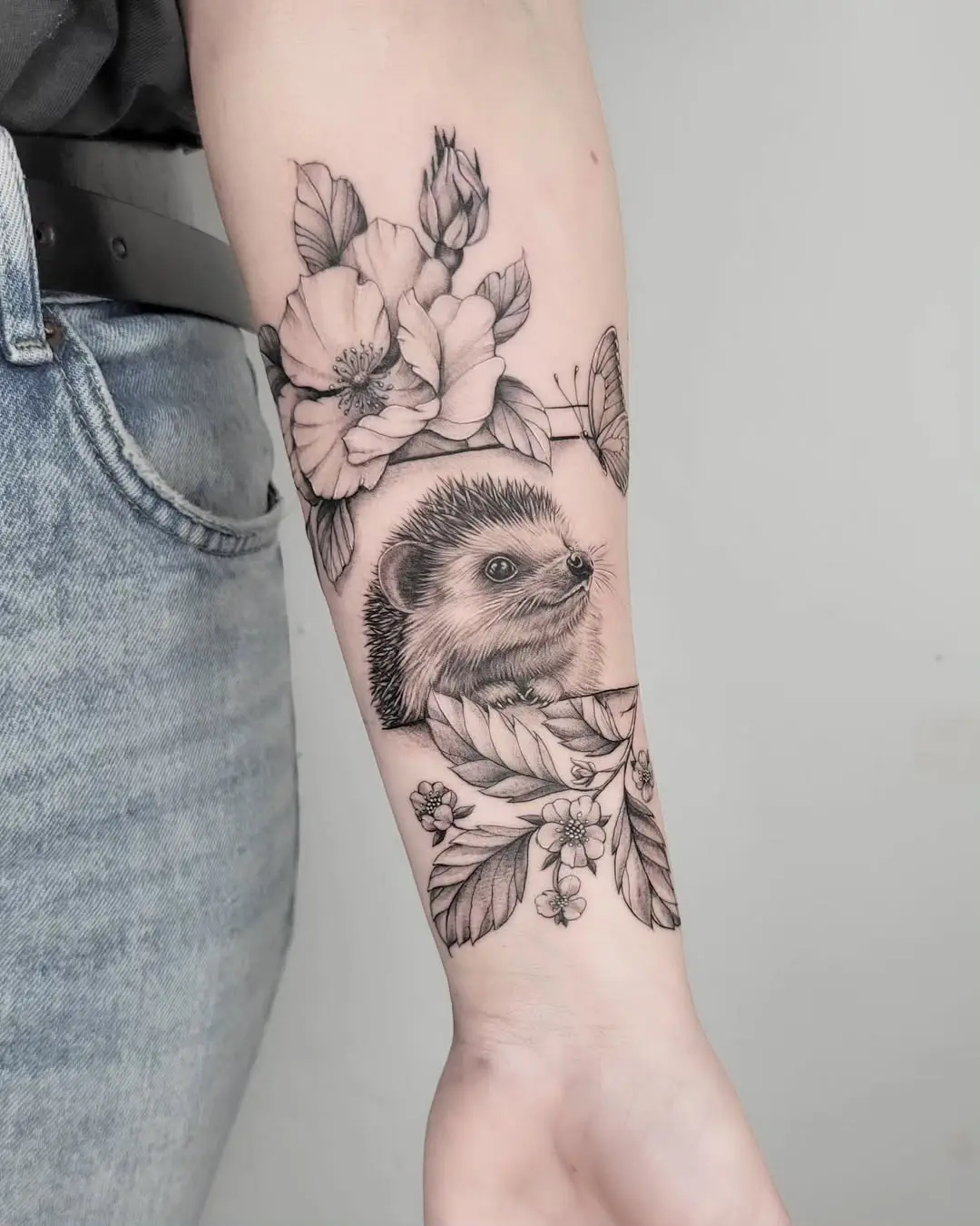 Stunning hedgehog tattoo with floral accents