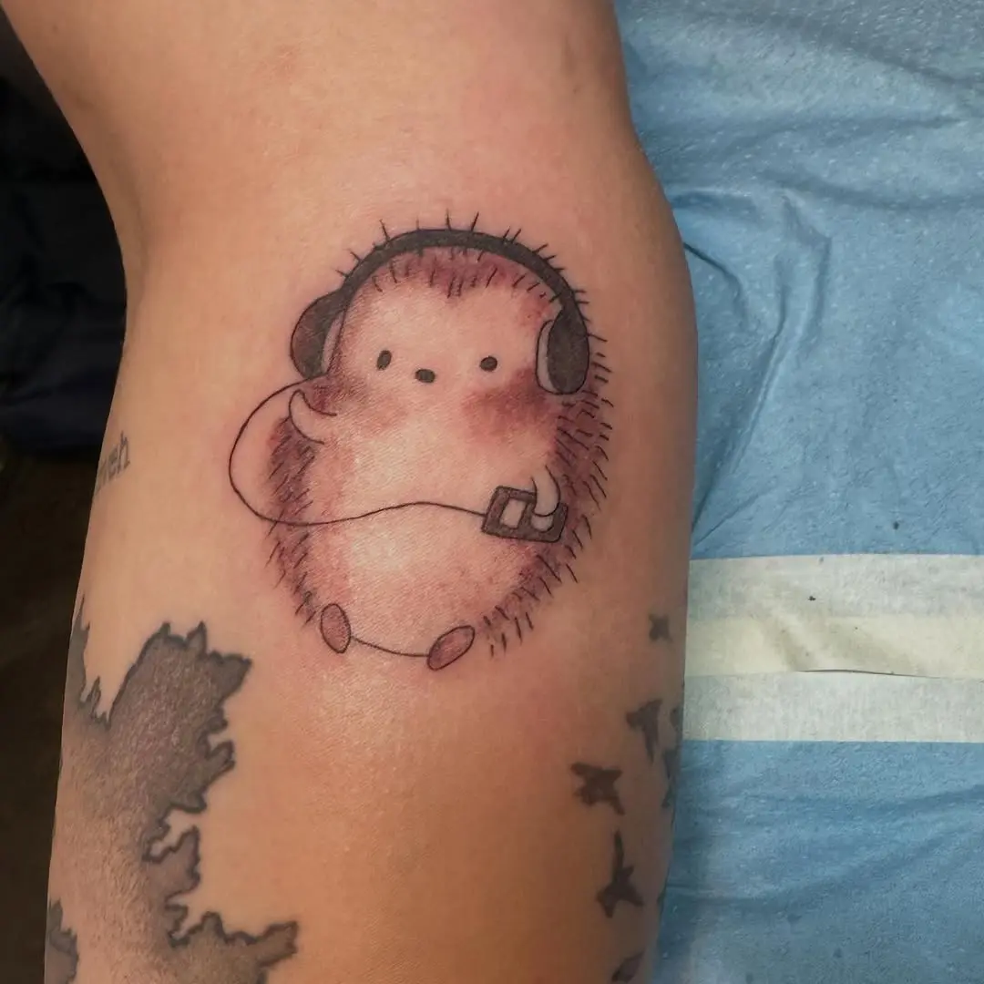 Adorable hedgehog tattoo with headphones vibe