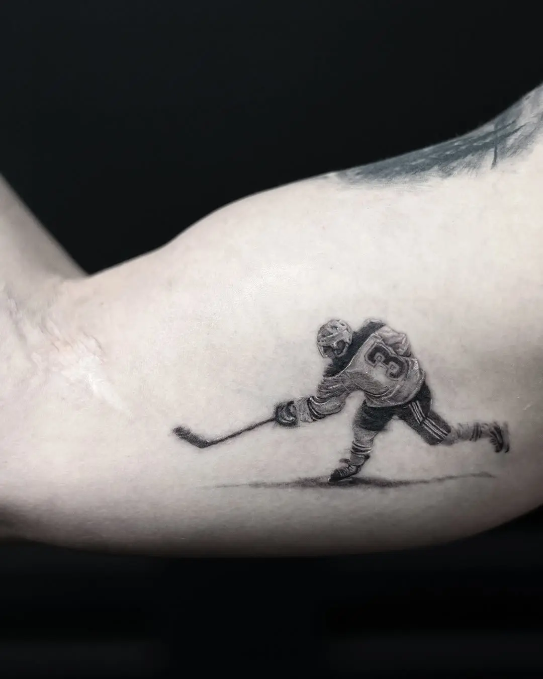Dynamic hockey tattoo showcasing a slap shot