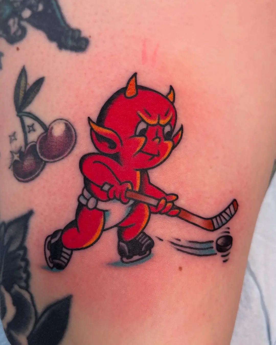 Vibrant devil mascot playing hockey tattoo