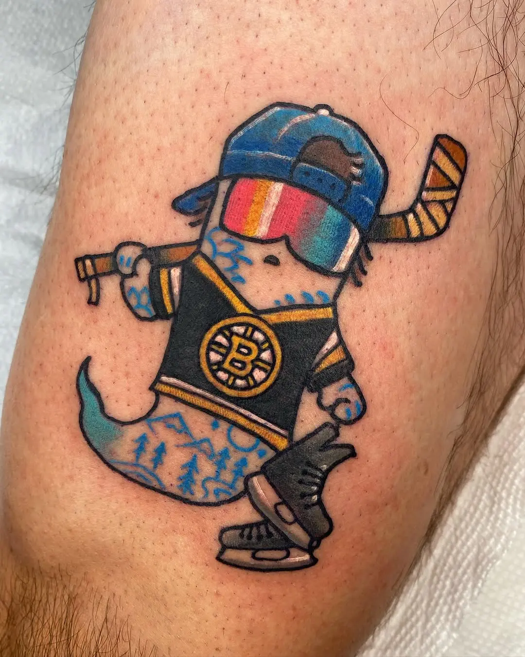Vibrant cartoon ghost playing hockey tattoo