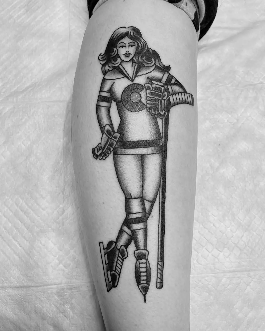 Stylish hockey player tattoo capturing athleticism.