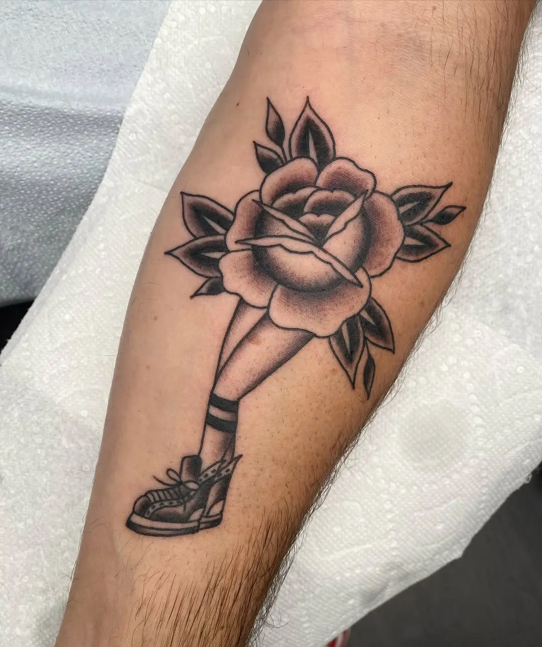 Intricate leg tattoo blending sports and nature