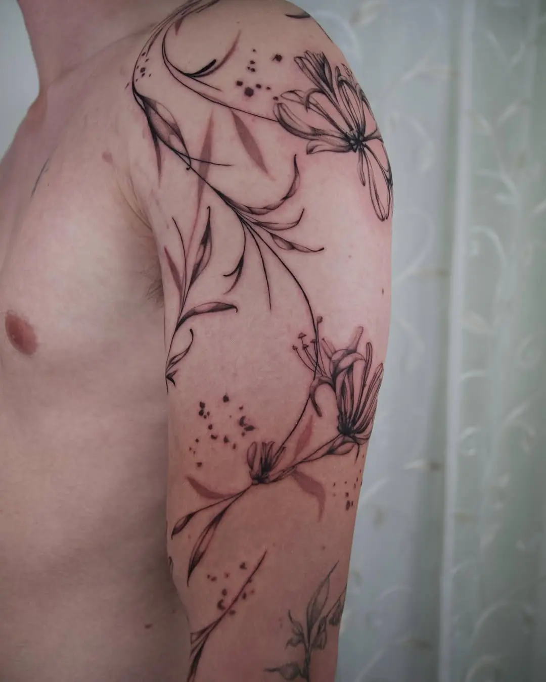 Elegant honeysuckle tattoo with delicate floral details