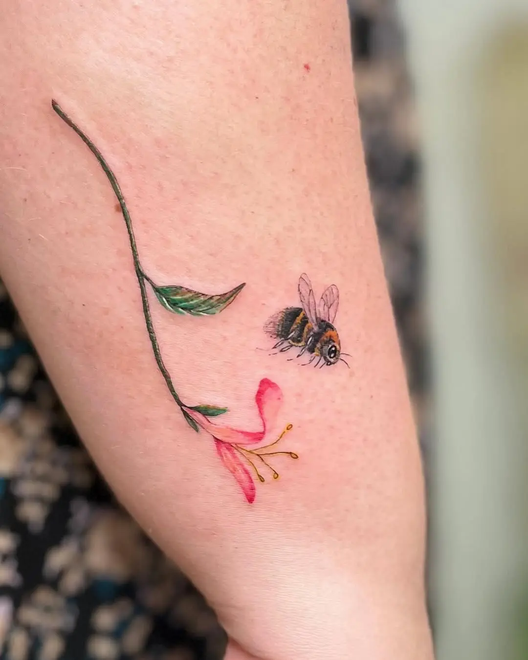 Whimsical honeysuckle tattoo with bee illustration