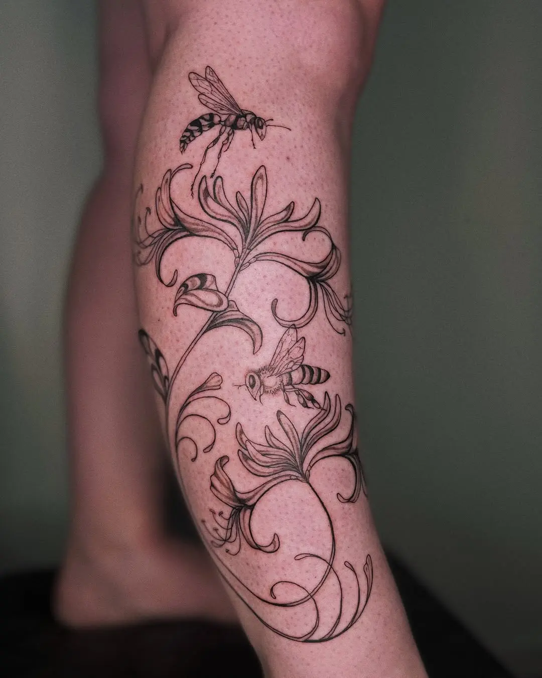 Elegant honeysuckle and bees tattoo design