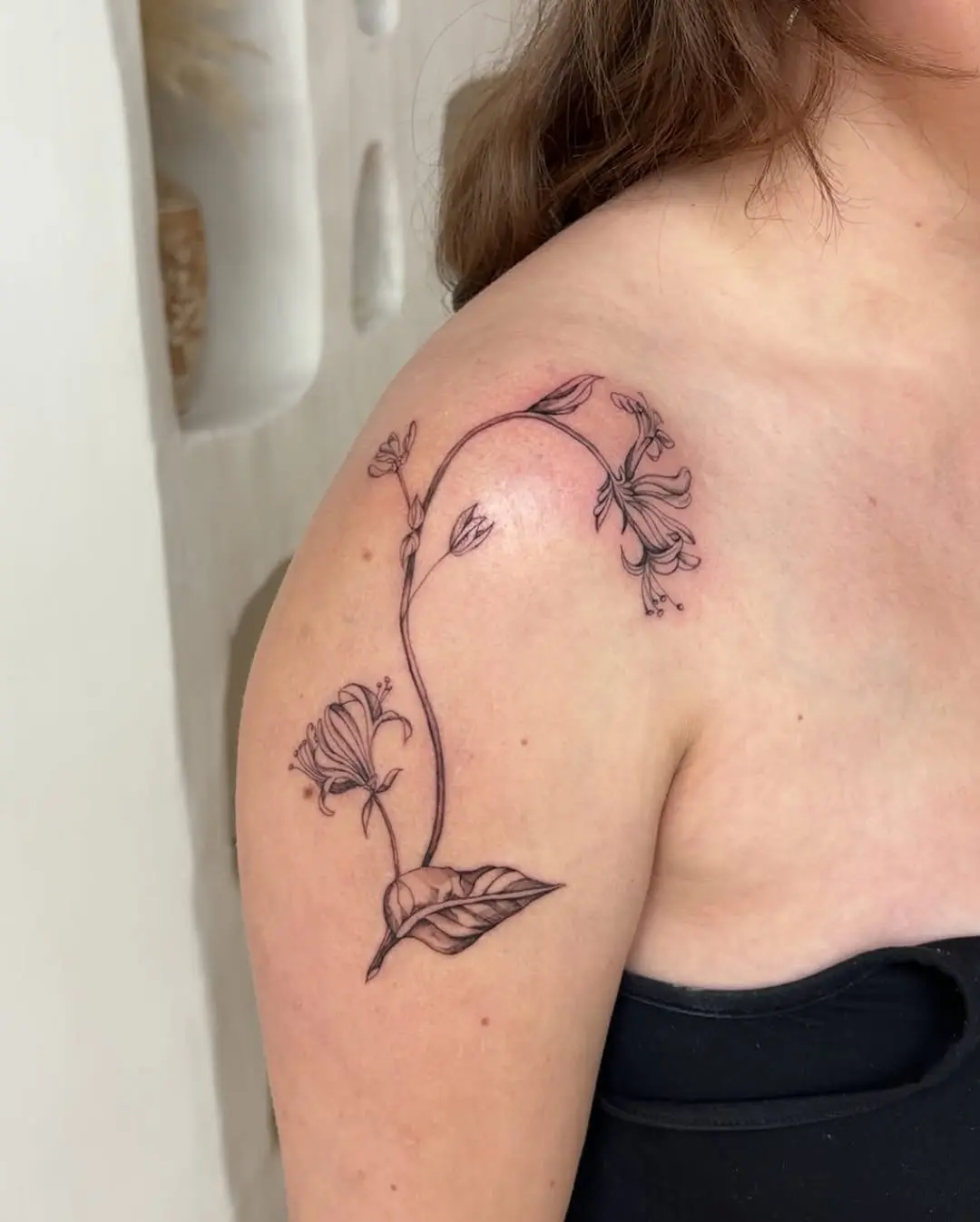 Elegant honeysuckle design on shoulder