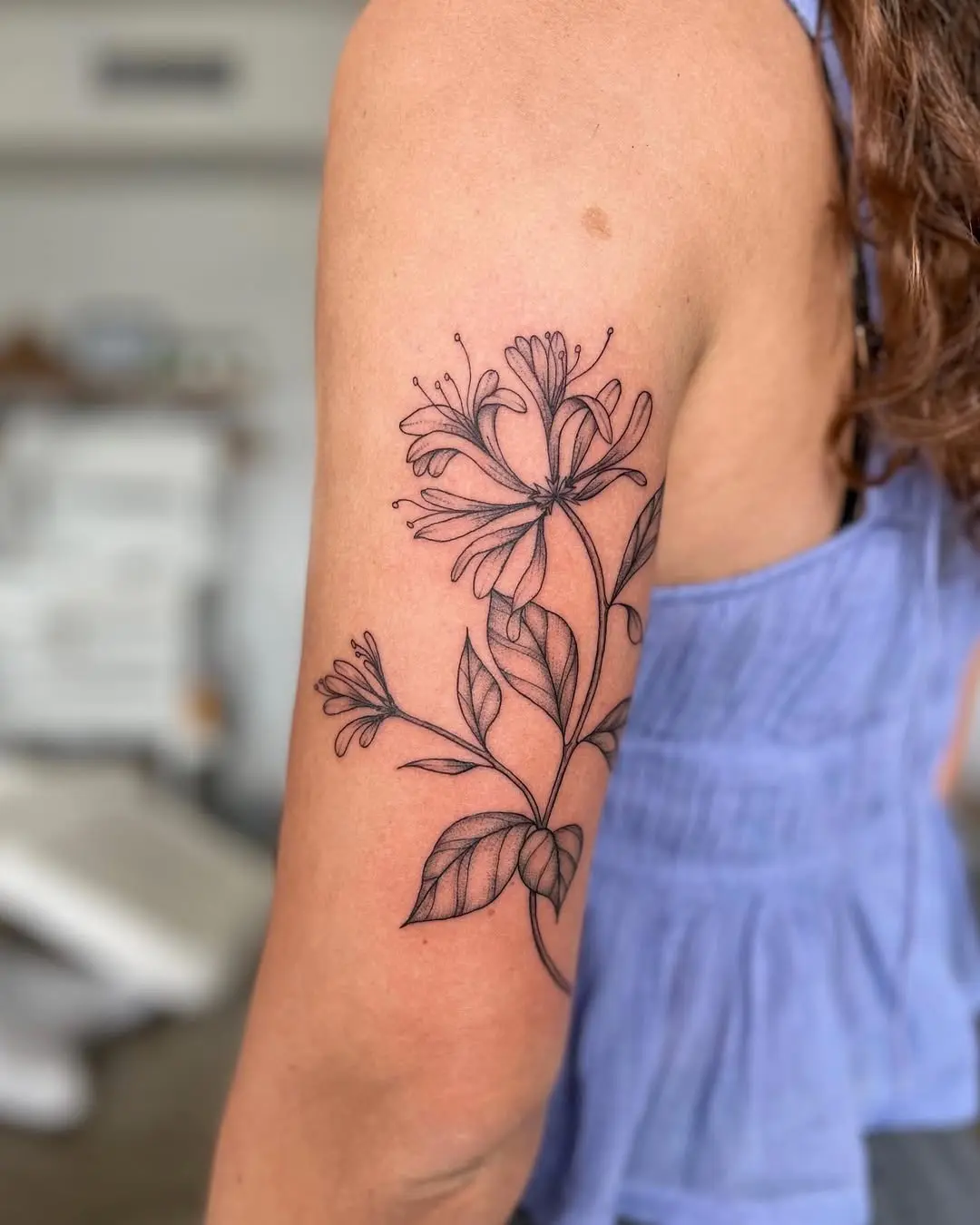 Elegant honeysuckle tattoo showcasing delicate lines