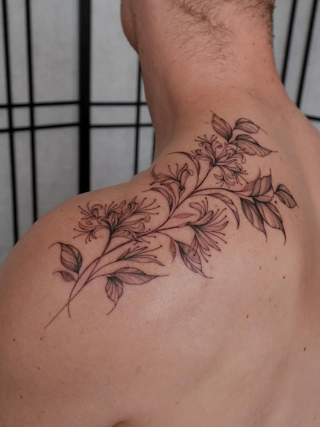 Elegant honeysuckle tattoo on the shoulder