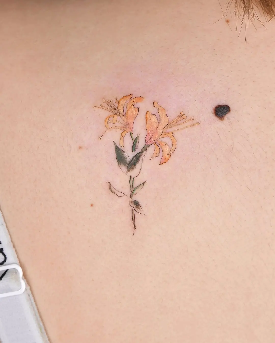 Charming honeysuckle tattoo with soft colors
