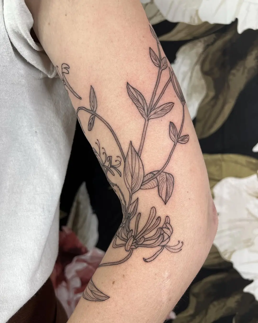 Elegant honeysuckle tattoo with fine line details