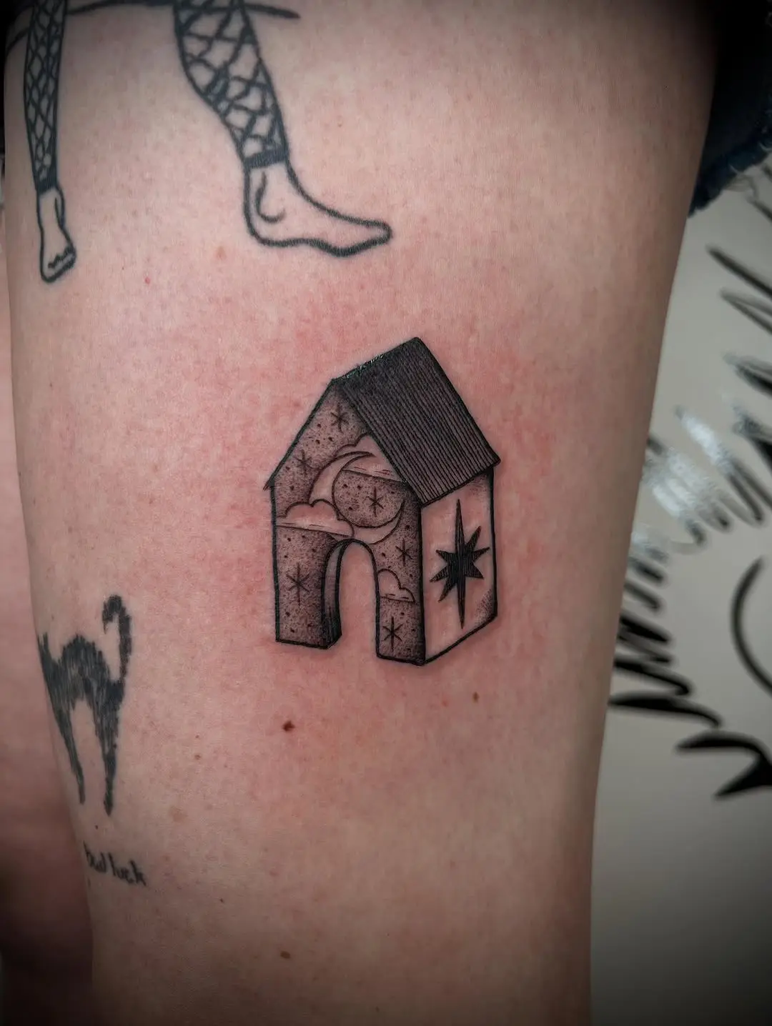 Charming house tattoo with celestial themes